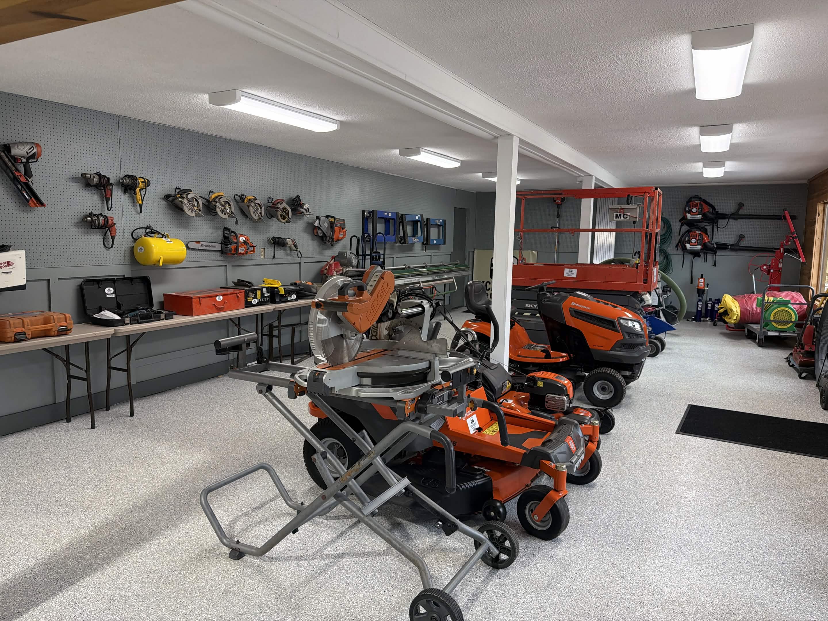 Rice Creek Rentals indoor showroom with power tools, miter saws, and riding mowers